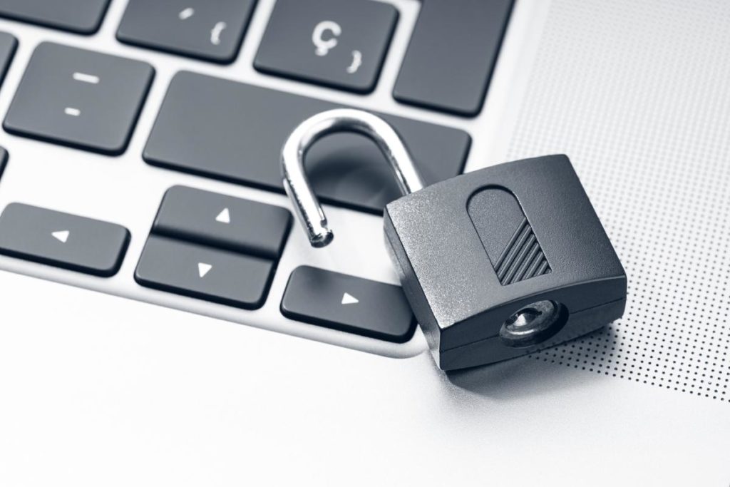photo of an unlocked padlock on laptop keyword