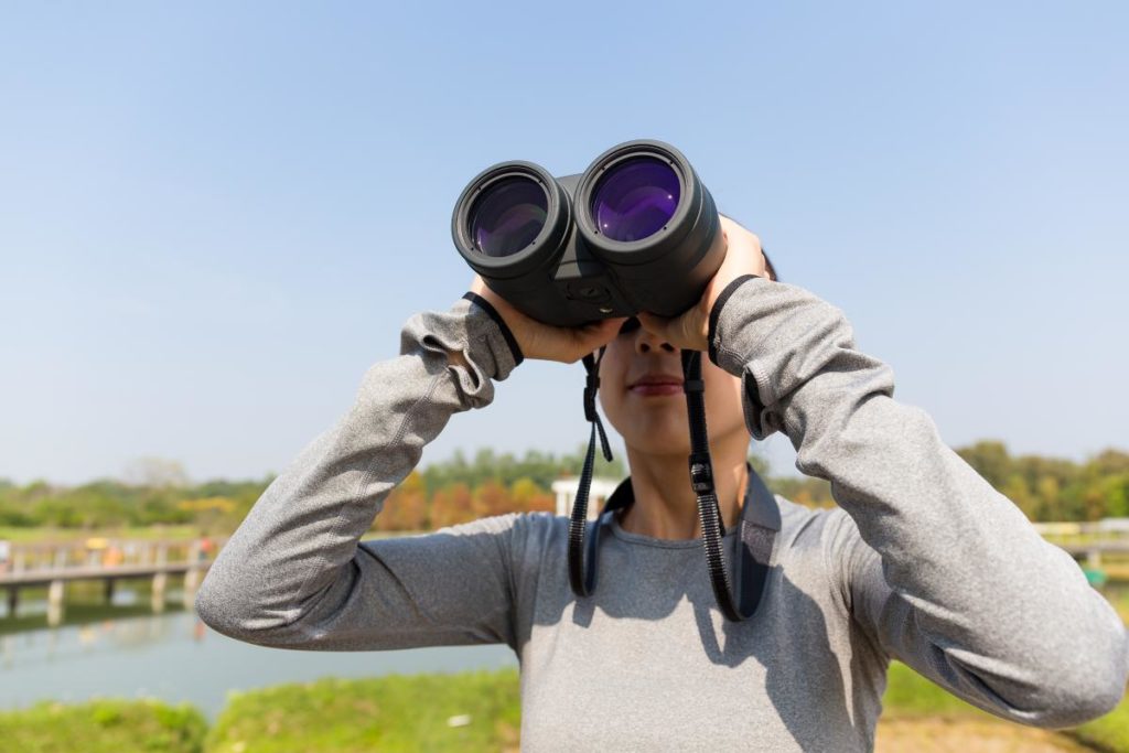 photo of women looking through binoculars