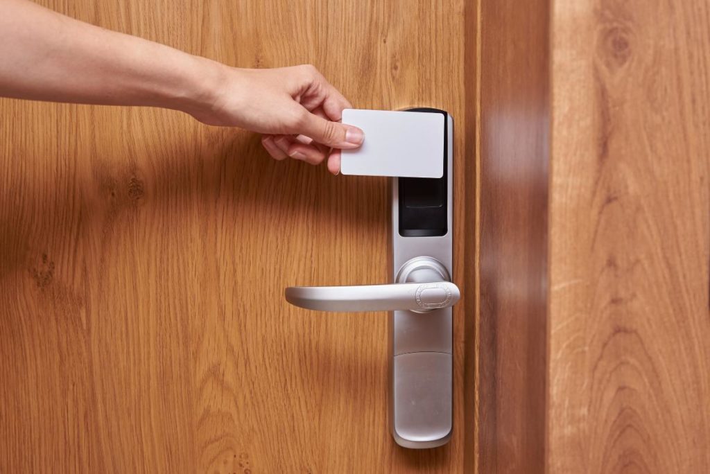 photo of someone unlocking a door with a digital keycard.