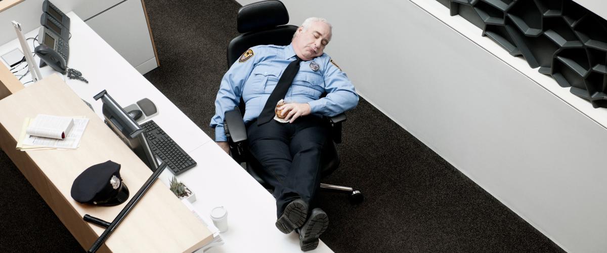 photo of a security guard sleeping on duty.