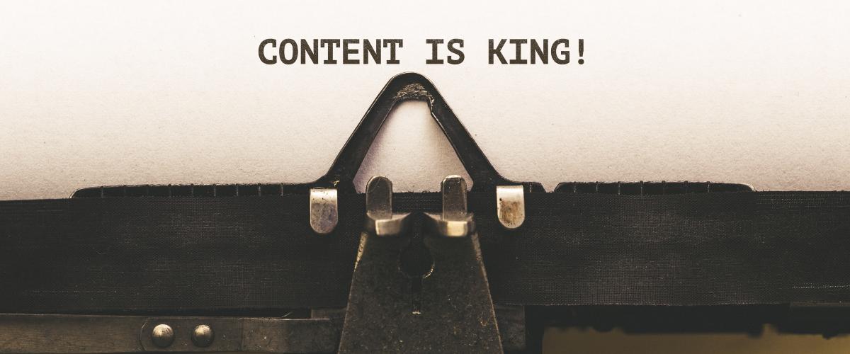 Close up of a typewriter that says "content is king"